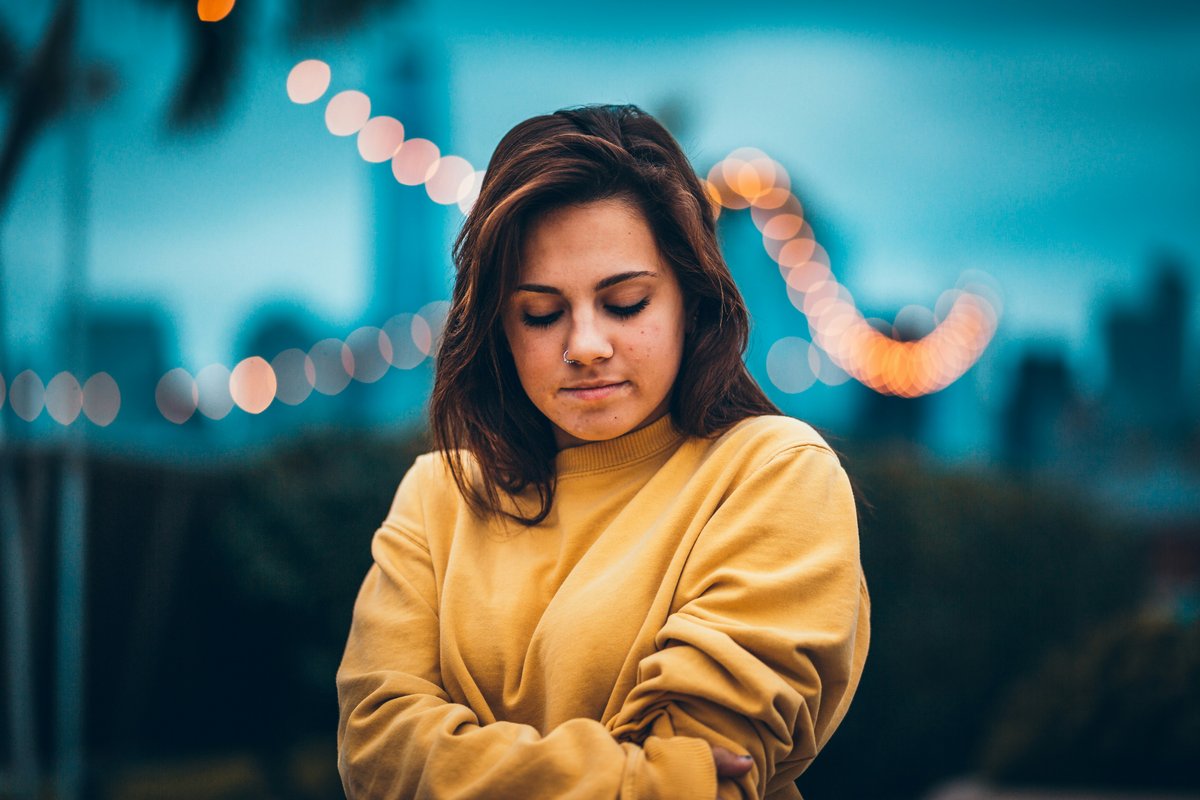 A woman in warm light, thoughtful and settled, sure of what she knows